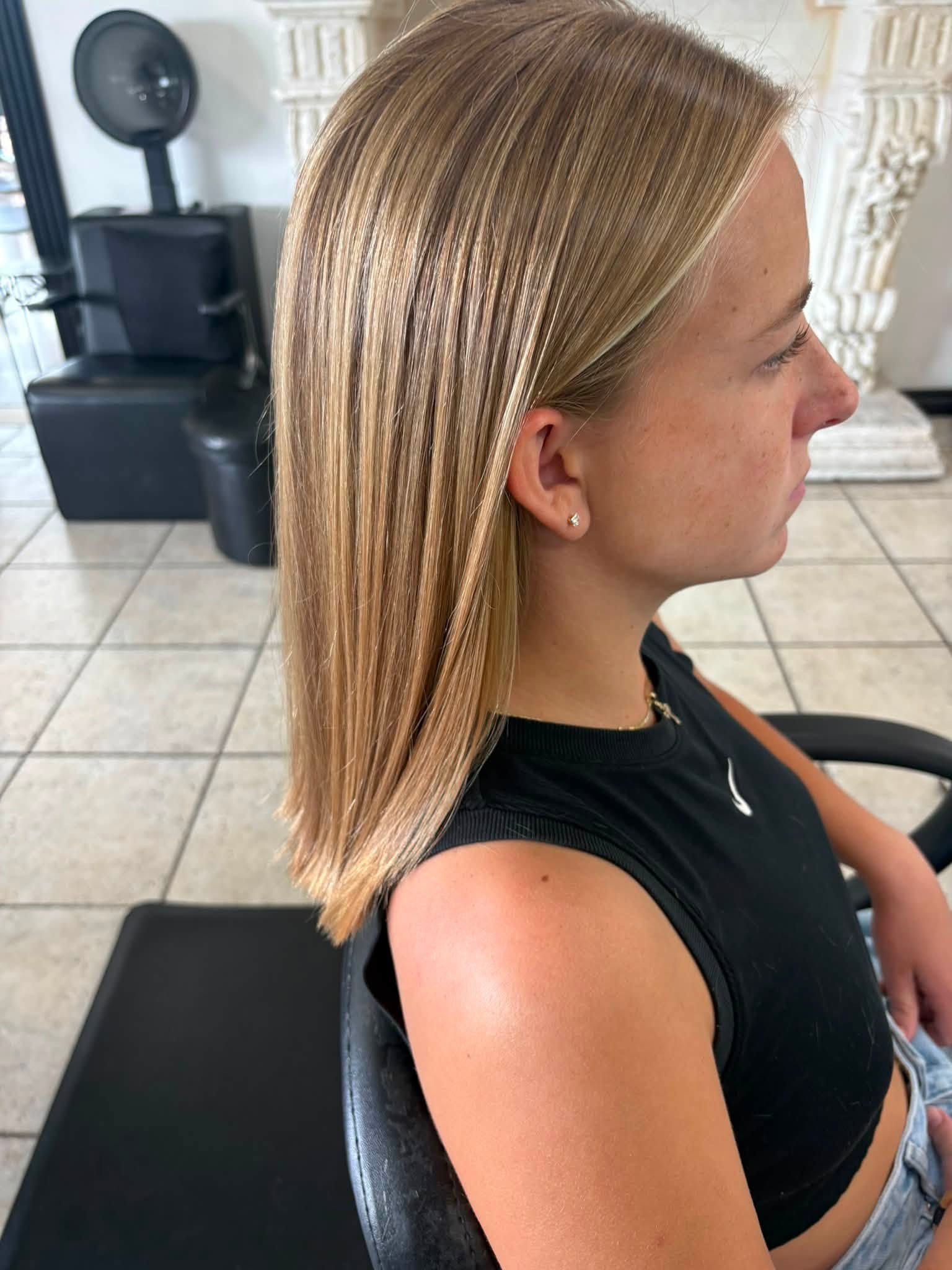 Side view of a precision blonde long bob